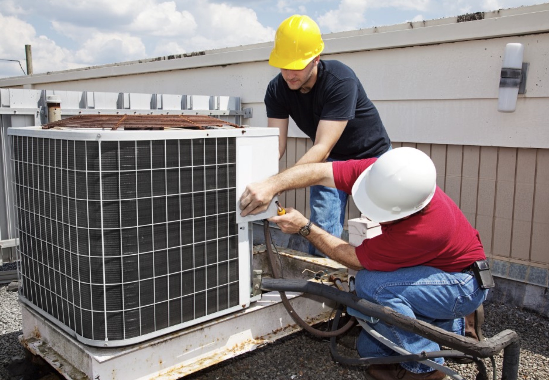 Brenk crew servicing a rooftop HVAC unit
